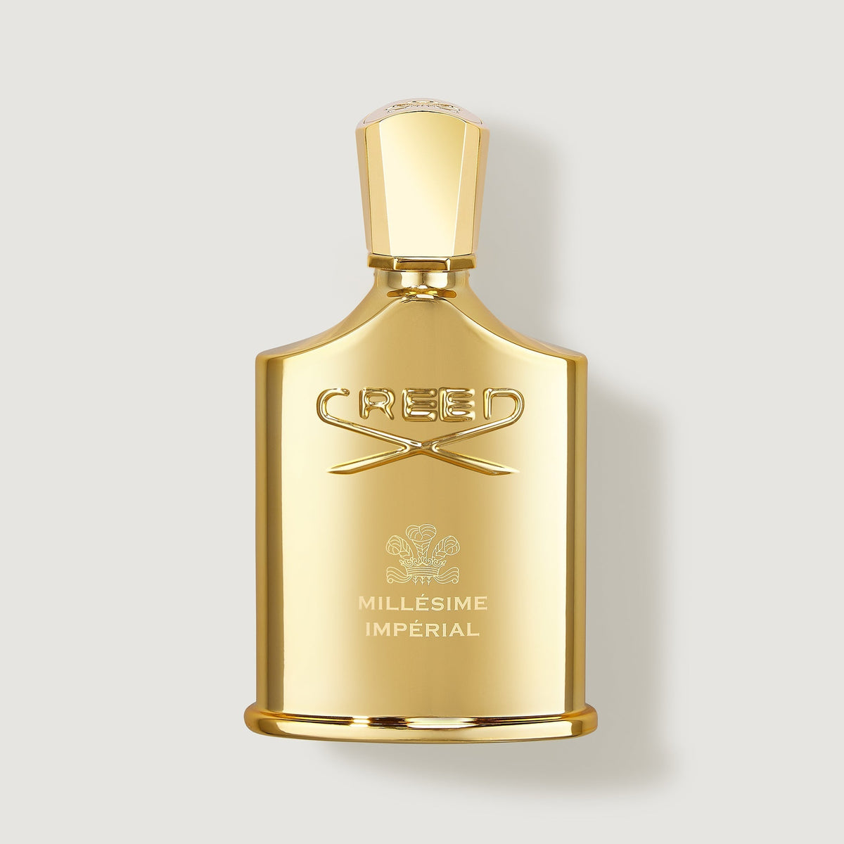 Gold Creed Millesime Imperial perfume bottle on a light gray background