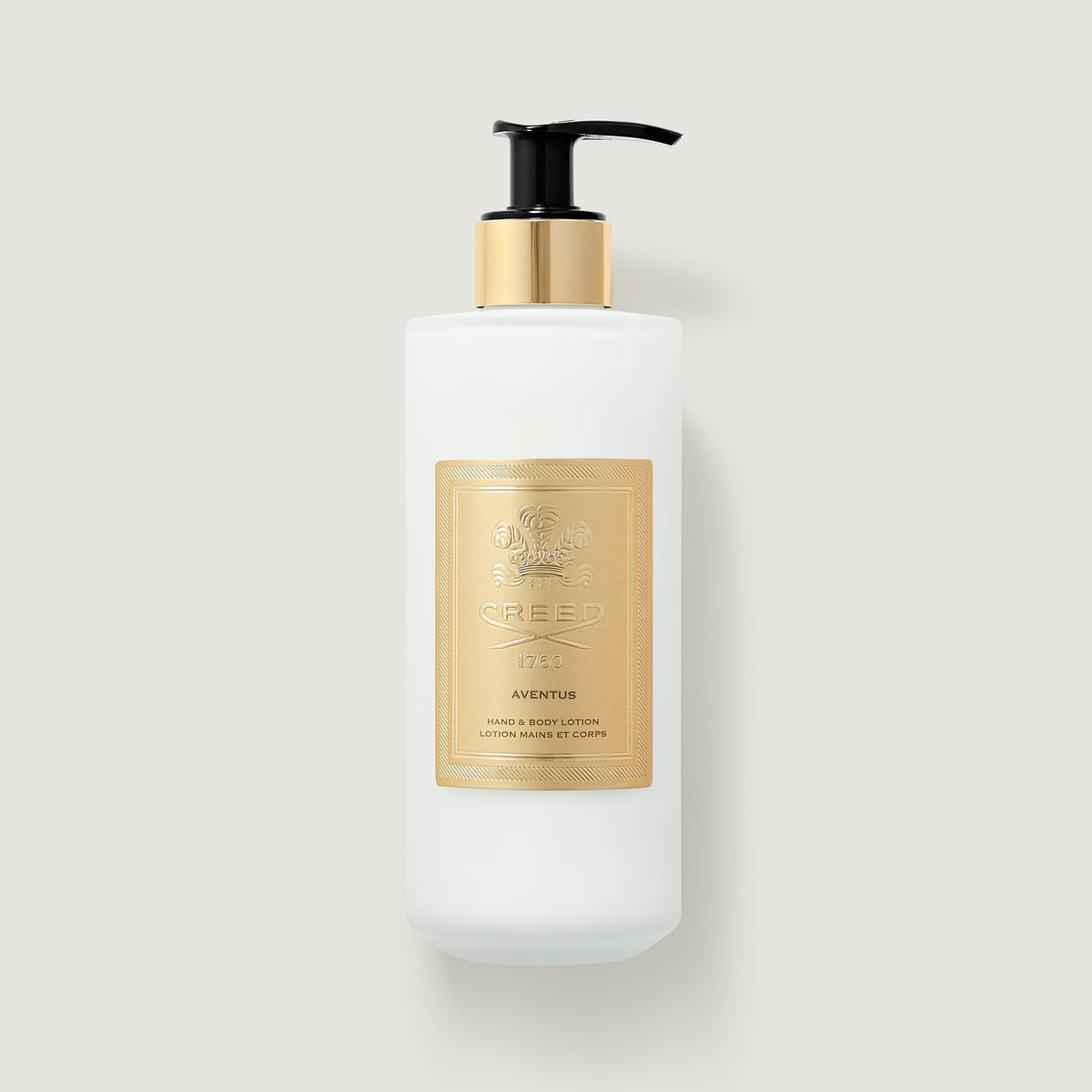 White lotion bottle with gold label on a light gray background