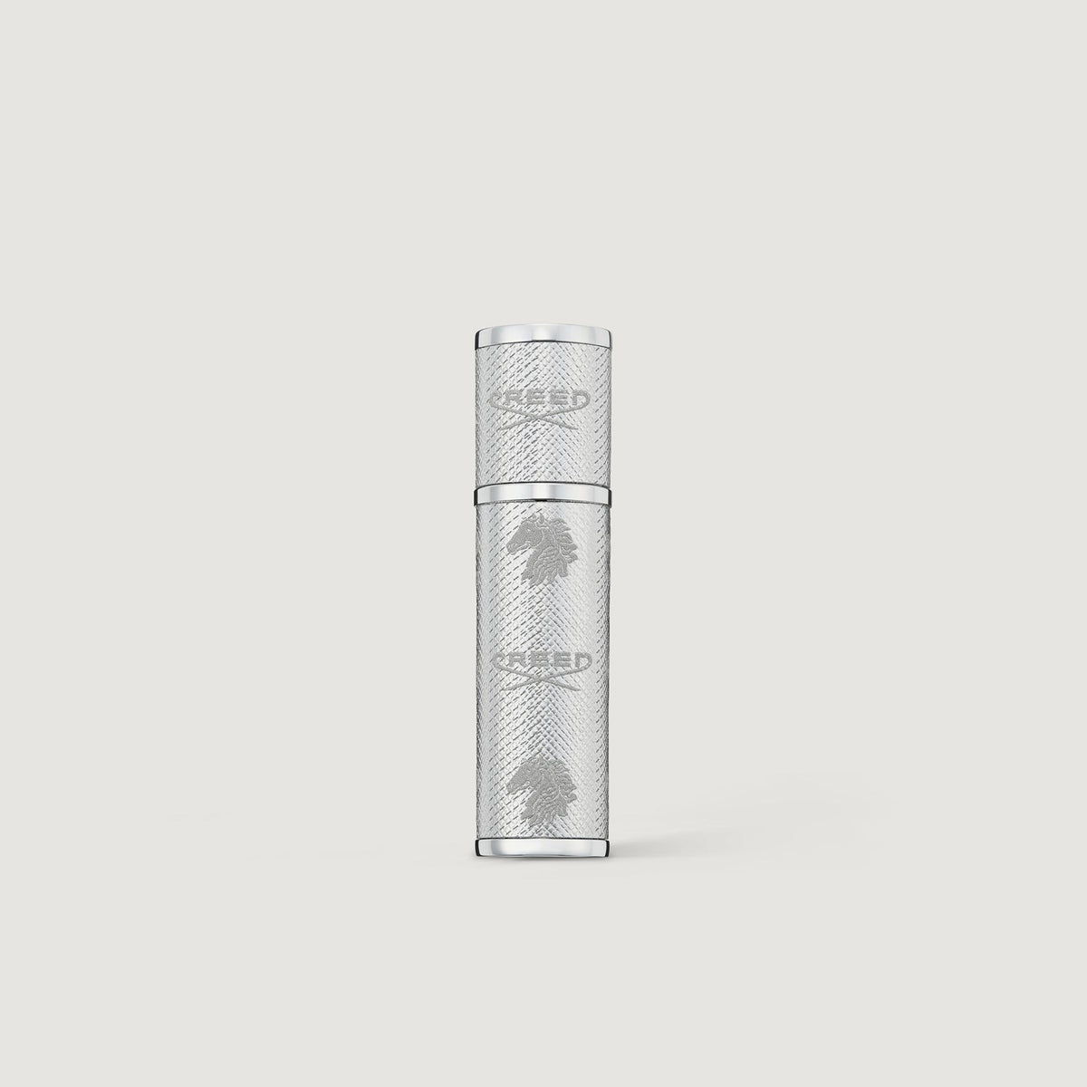 Creed silver leather 5ml perfume atomizer on a light gray background
